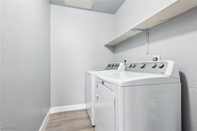 laundry room featuring light wood-type flooring, laundry area, baseboards, and washer and clothes dryer