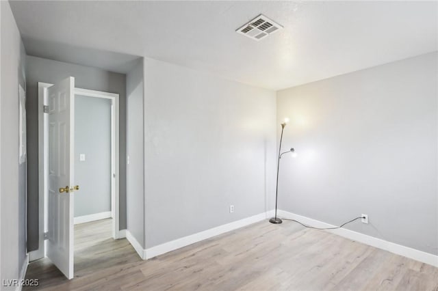 interior space featuring baseboards, visible vents, and wood finished floors