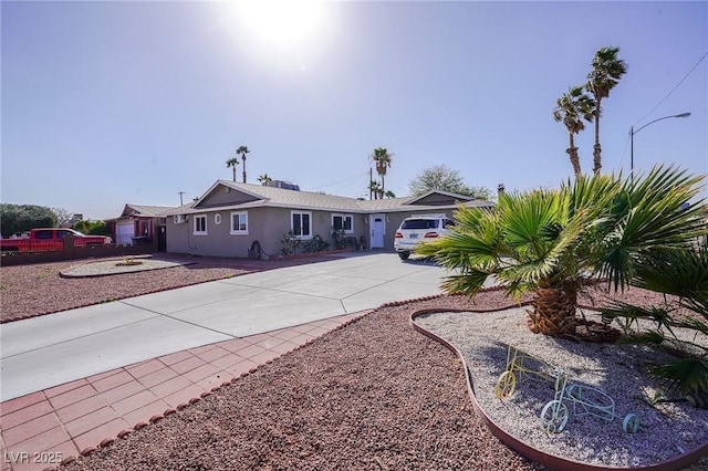 single story home with driveway and stucco siding