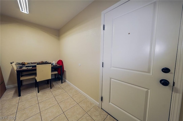 home office featuring baseboards and light tile patterned flooring