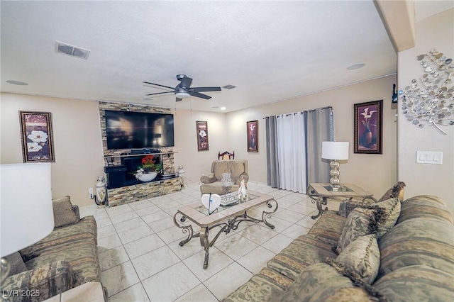 living room with visible vents, ceiling fan, and tile patterned floors