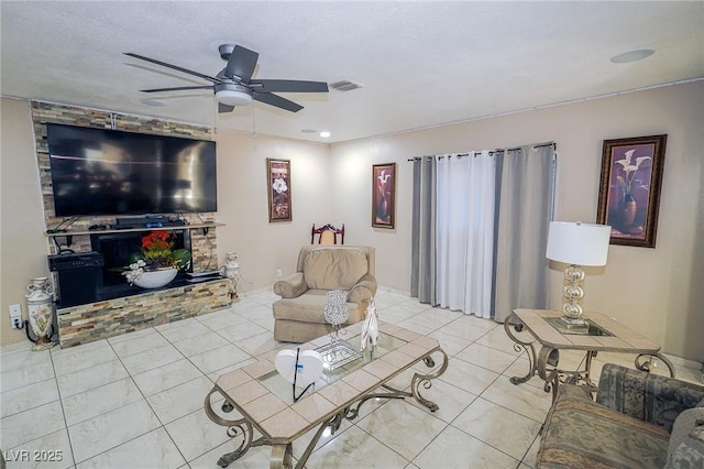 tiled living room featuring visible vents and a ceiling fan