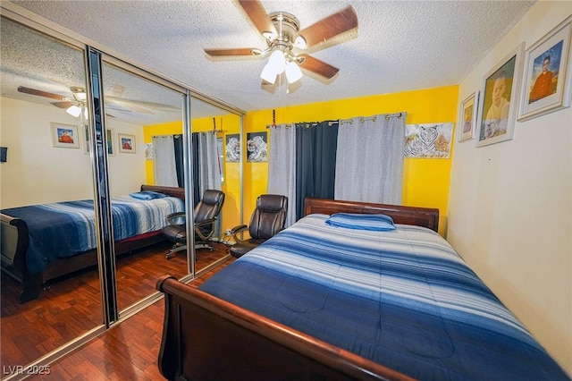 bedroom featuring a textured ceiling, ceiling fan, a closet, and wood finished floors