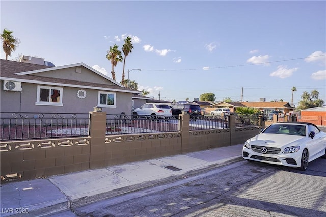 view of front of house featuring a fenced front yard and stucco siding