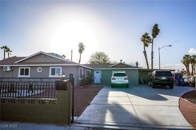 single story home with driveway and stucco siding