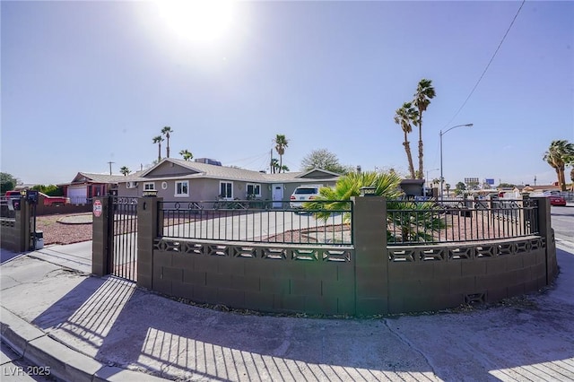 view of gate with a fenced front yard