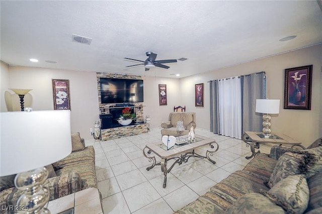 living room featuring tile patterned flooring, visible vents, ceiling fan, and recessed lighting