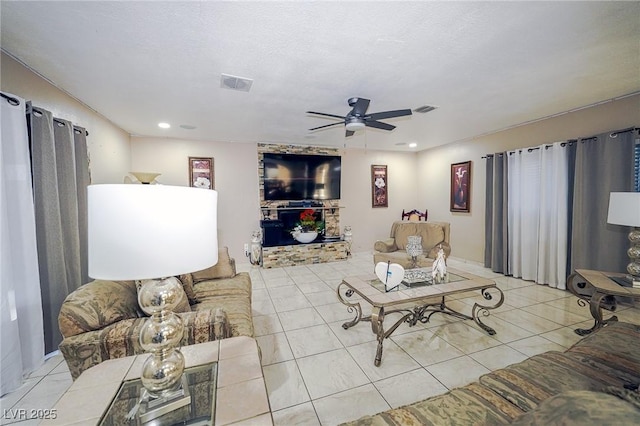 tiled living room with recessed lighting, visible vents, and a ceiling fan