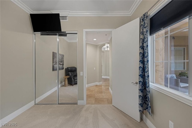 unfurnished bedroom featuring carpet, ornamental molding, and a closet