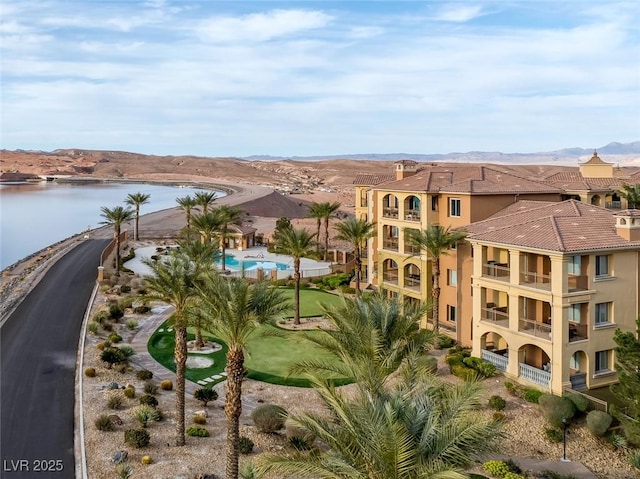 exterior space with a water and mountain view