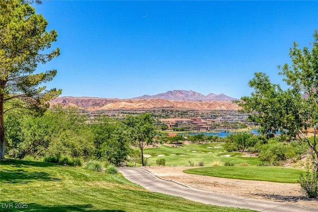 surrounding community with a lawn and a mountain view