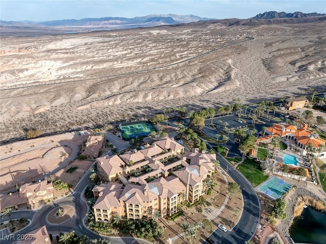 birds eye view of property with a mountain view