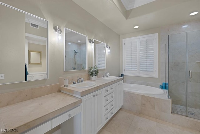 full bath with a sink, visible vents, a bath, double vanity, and a stall shower