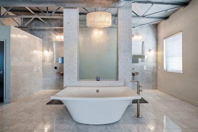 full bathroom with a freestanding bath and tile walls