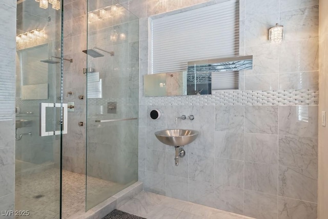 full bathroom featuring a stall shower and a sink