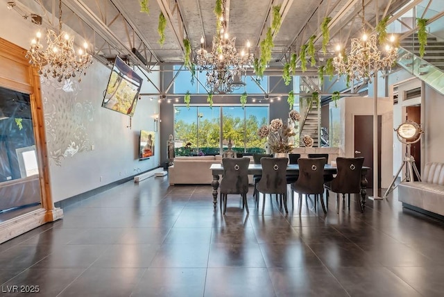 dining room featuring a towering ceiling and an inviting chandelier