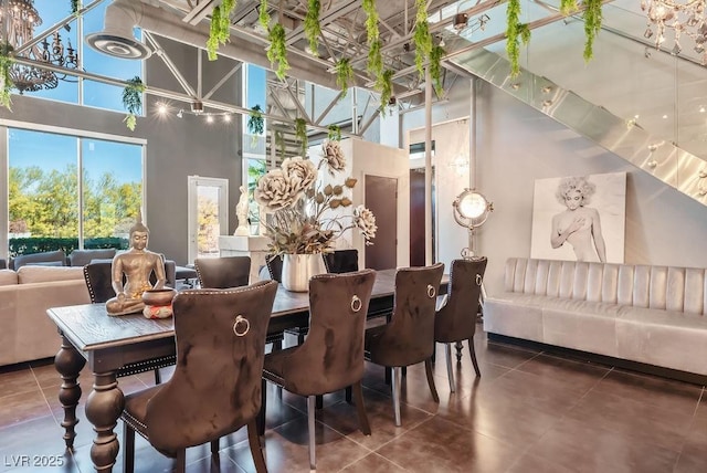 dining space with a high ceiling and tile patterned floors