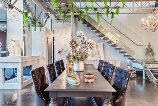 dining room featuring a high ceiling, stairway, and an inviting chandelier