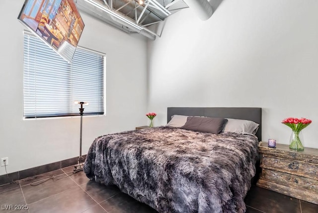 bedroom with tile patterned flooring and baseboards