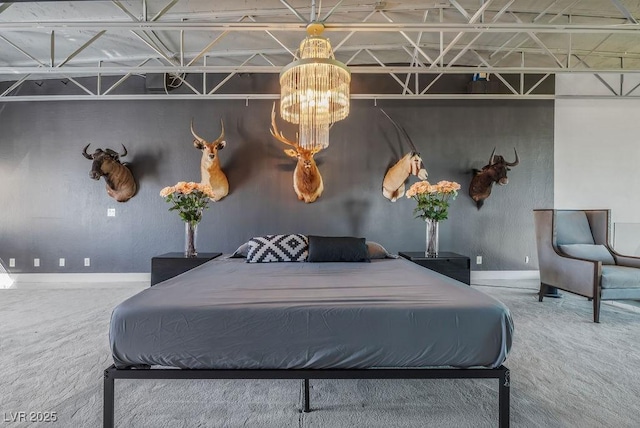 bedroom featuring a chandelier, carpet, and baseboards