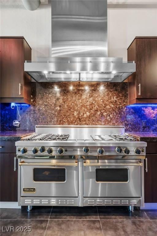 kitchen featuring decorative backsplash, dark countertops, exhaust hood, and double oven range