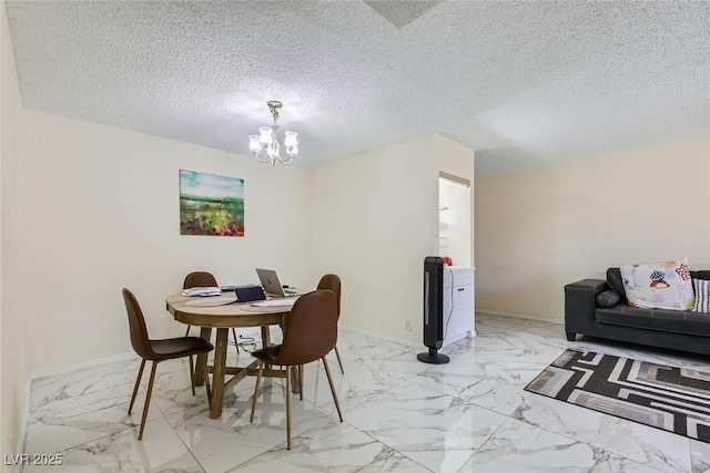 dining area with marble finish floor, baseboards, and an inviting chandelier