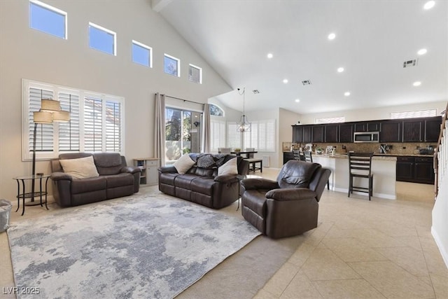 living room with recessed lighting, visible vents, a high ceiling, and light tile patterned flooring