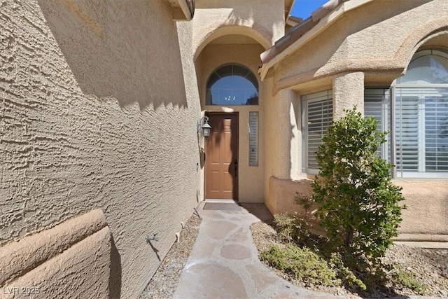 entrance to property with stucco siding