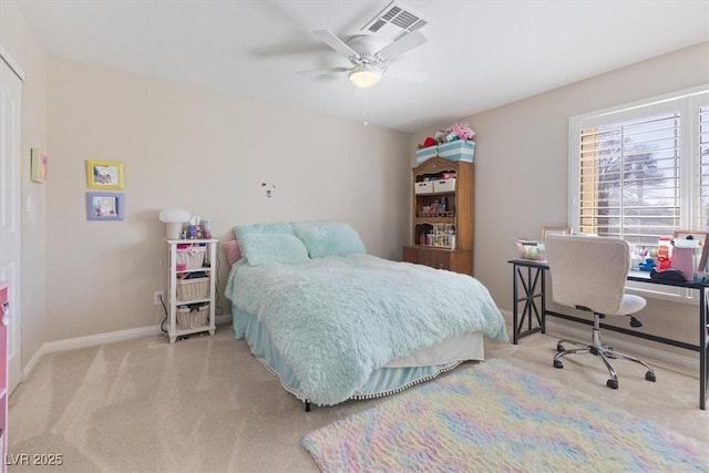 carpeted bedroom with visible vents, baseboards, and ceiling fan