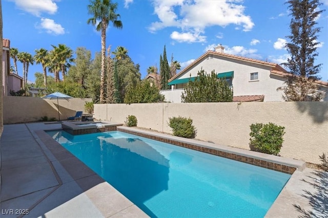 view of pool featuring a pool with connected hot tub, a fenced backyard, and a patio