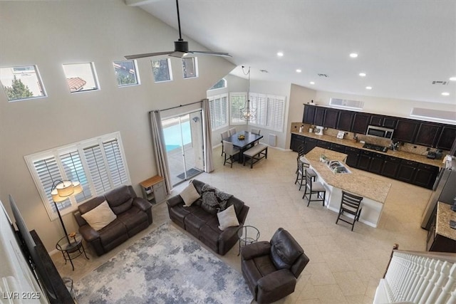 living room featuring light tile patterned floors, visible vents, ceiling fan, high vaulted ceiling, and recessed lighting