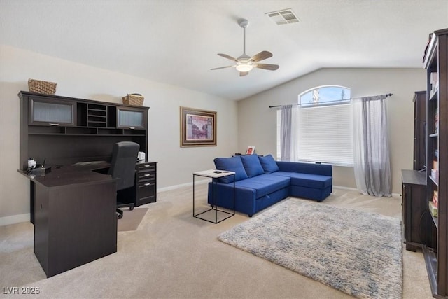 home office featuring light carpet, visible vents, baseboards, lofted ceiling, and ceiling fan