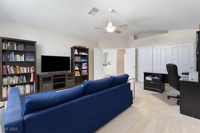 living area featuring lofted ceiling, visible vents, ceiling fan, and light carpet