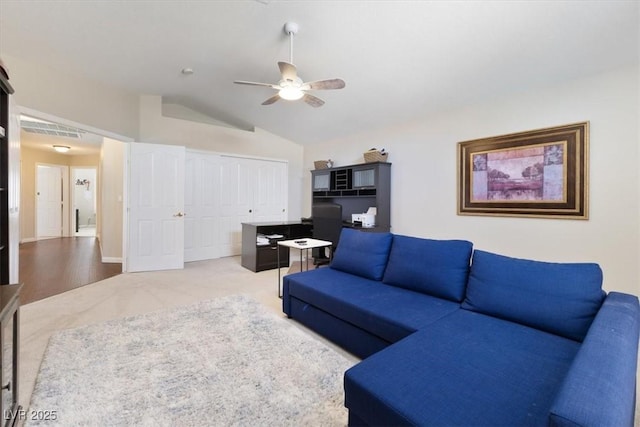 living room featuring carpet floors, lofted ceiling, and ceiling fan