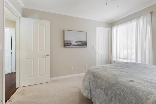 carpeted bedroom featuring ornamental molding and baseboards