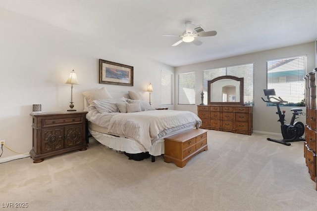 carpeted bedroom with a ceiling fan and baseboards