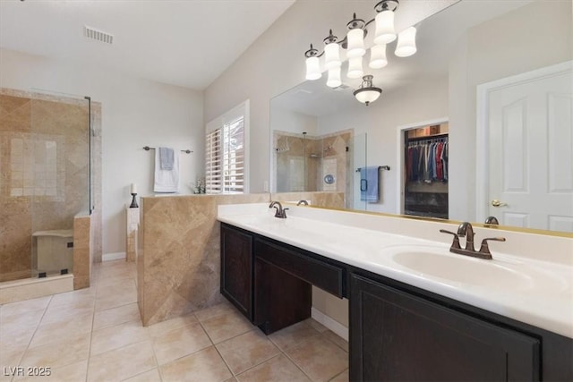 full bath with double vanity, visible vents, a stall shower, a sink, and tile patterned floors