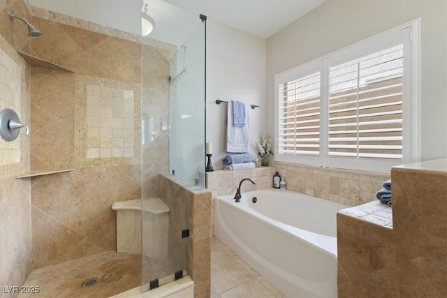 bathroom with tile patterned flooring, a garden tub, and a shower stall