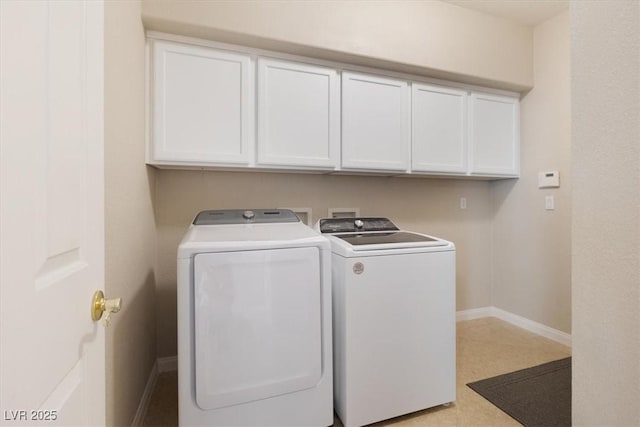 laundry area with independent washer and dryer, cabinet space, and baseboards