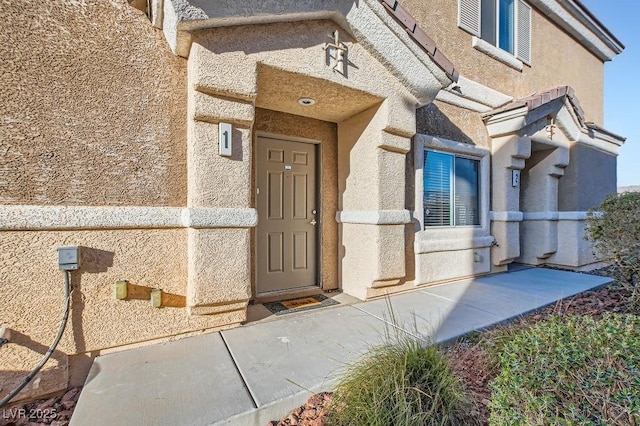 doorway to property with stucco siding