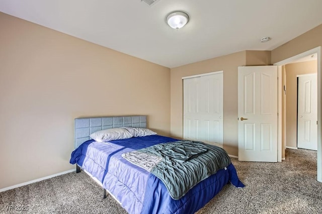 bedroom with a closet, visible vents, baseboards, and carpet