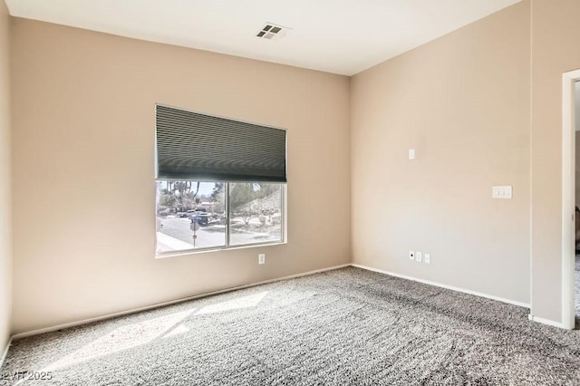 carpeted spare room with baseboards and visible vents