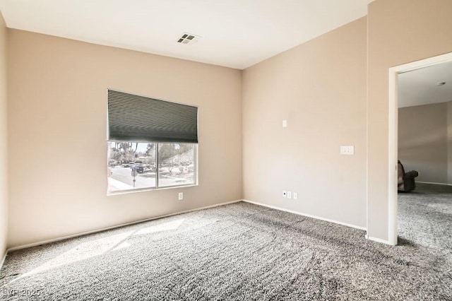 spare room with visible vents, baseboards, and carpet flooring