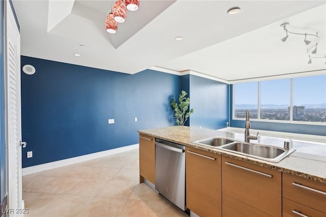 kitchen featuring light tile patterned floors, baseboards, a sink, dishwasher, and brown cabinets