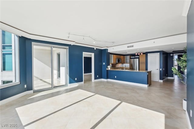 unfurnished living room with light tile patterned flooring, visible vents, and baseboards