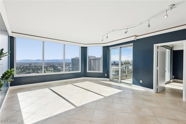 tiled spare room with baseboards and a city view