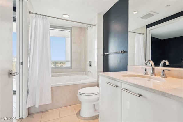 bathroom with vanity, visible vents, tile patterned flooring, toilet, and shower / tub combo with curtain