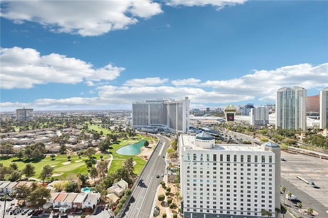 bird's eye view with a view of city, a water view, and view of golf course