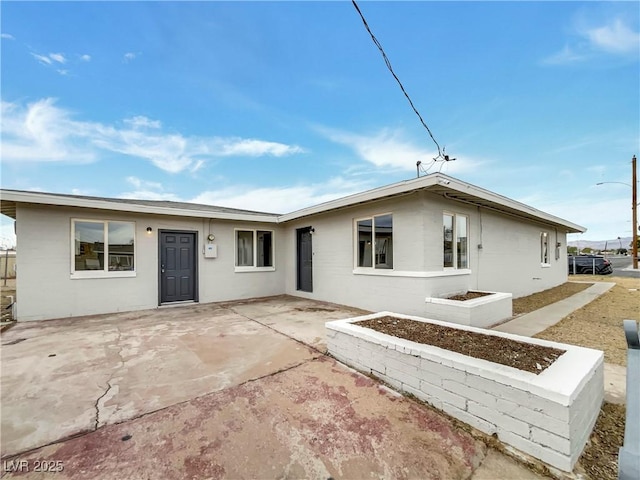 back of property with a patio