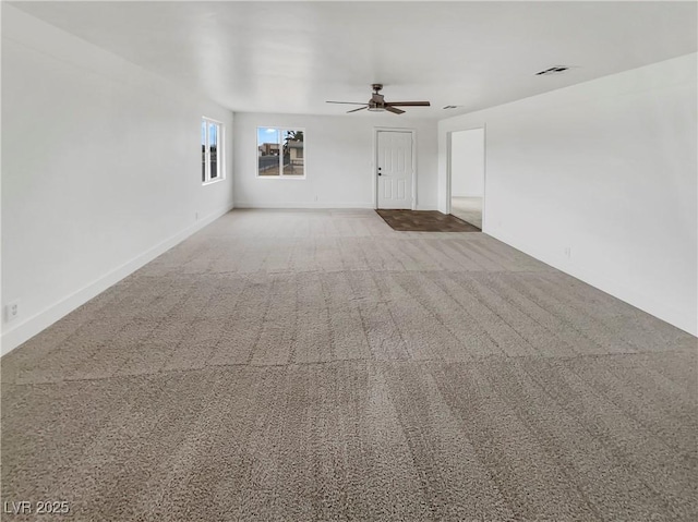 unfurnished living room featuring a ceiling fan, carpet, visible vents, and baseboards